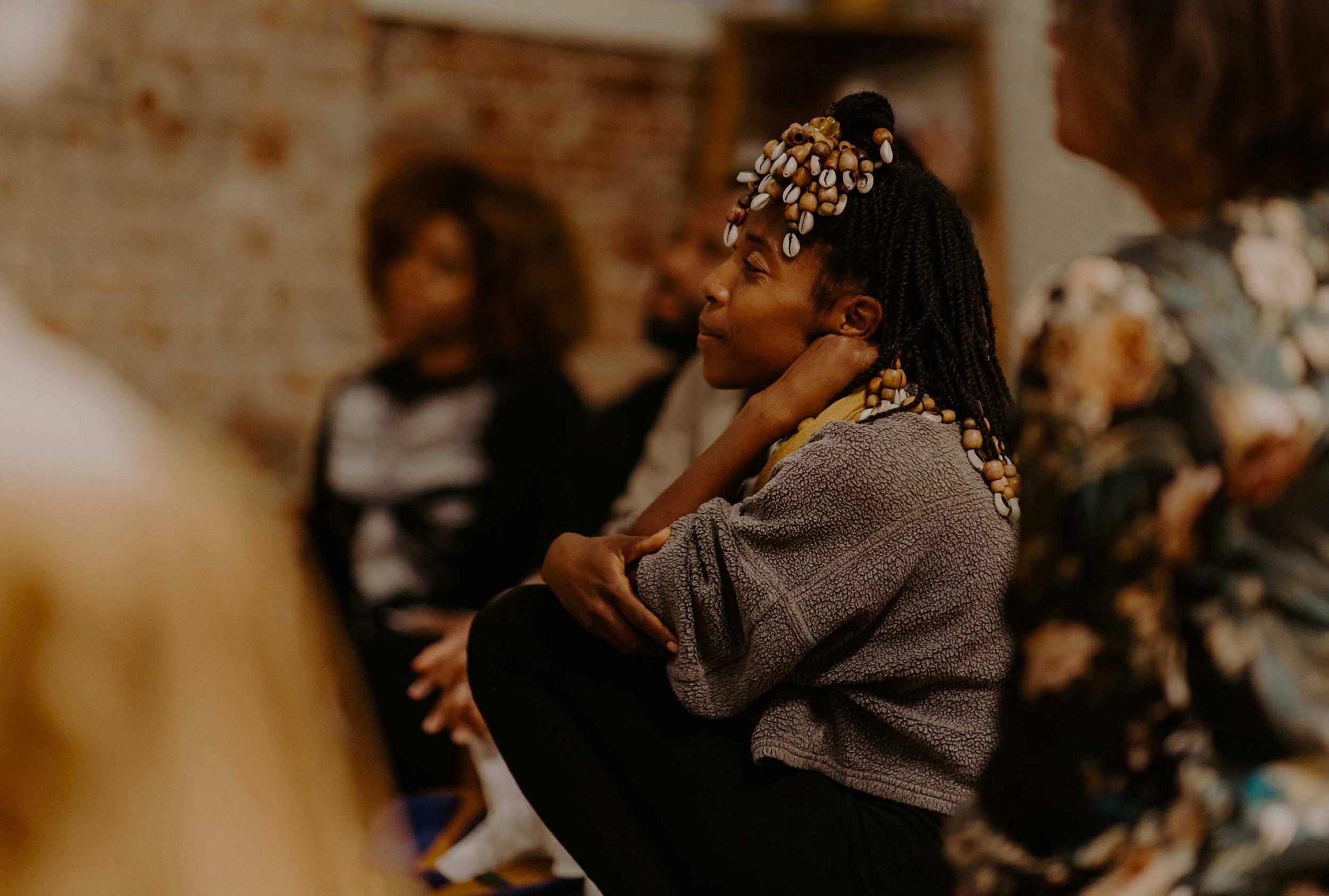 Group seated in meditation in the Black Being studio